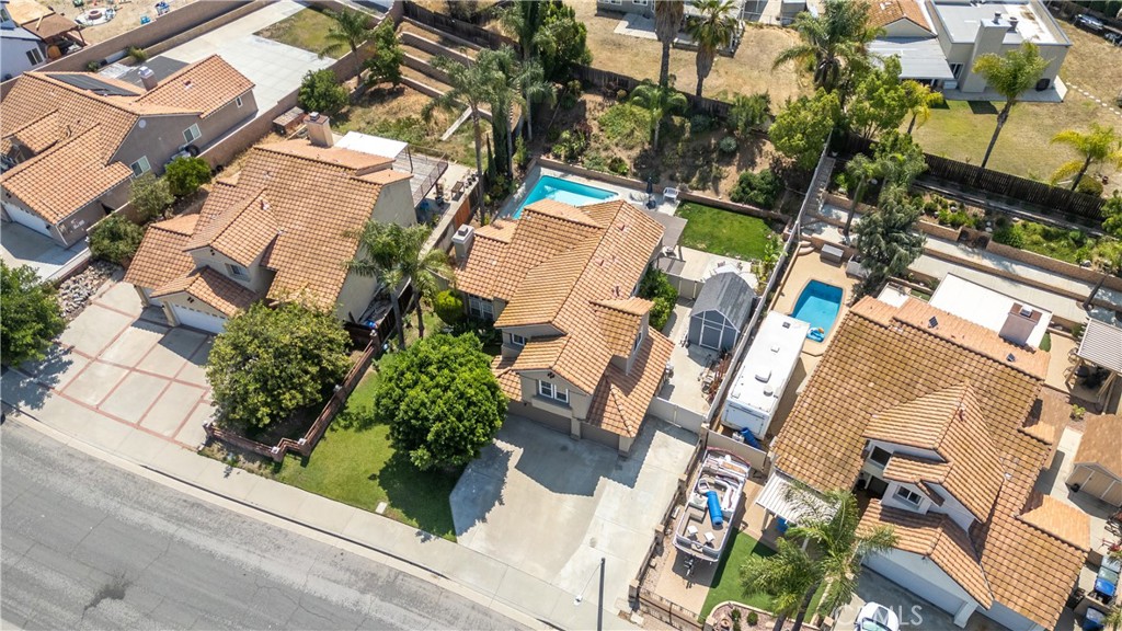 19465 Kinnow Lane Riverside, CA 92508 - Photo 54 of 61 an aerial view of a residential apartment building with a yard and parking spaces