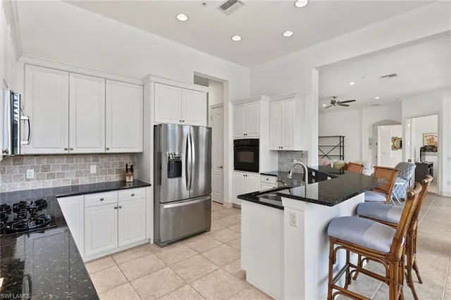a kitchen with stainless steel appliances a refrigerator sink and cabinets