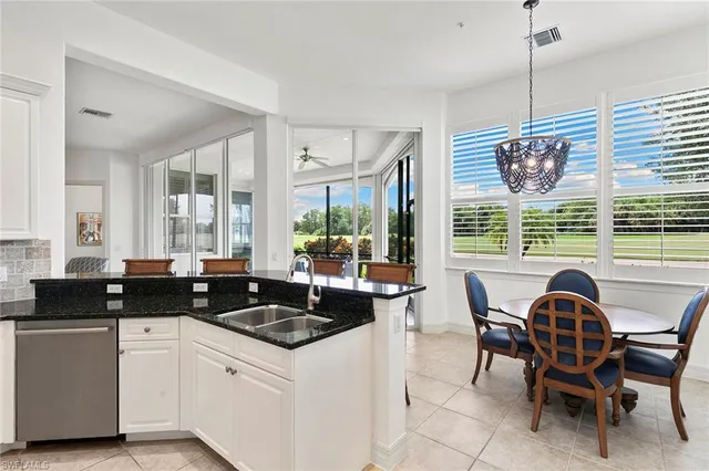 a kitchen with a stove a sink and cabinets