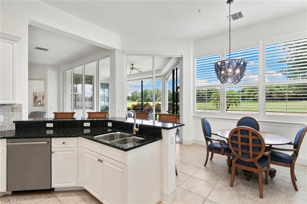 17005 Porta Vecchio Way, Unit 102 Naples, FL 34110 - Photo 13 of 50 a kitchen with a stove a sink and cabinets