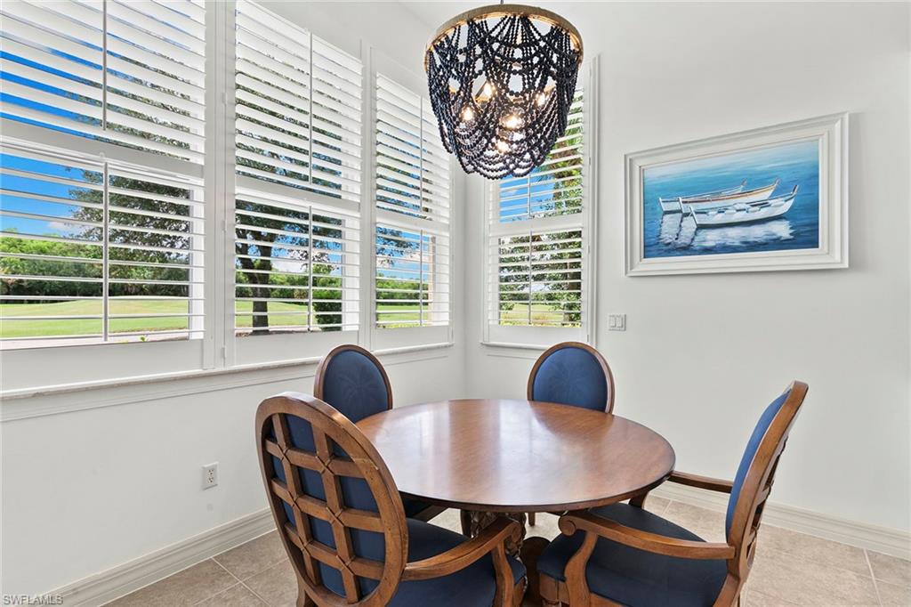 17005 Porta Vecchio Way, Unit 102 Naples, FL 34110 - Photo 14 of 50 a view of a dining room with furniture and window
