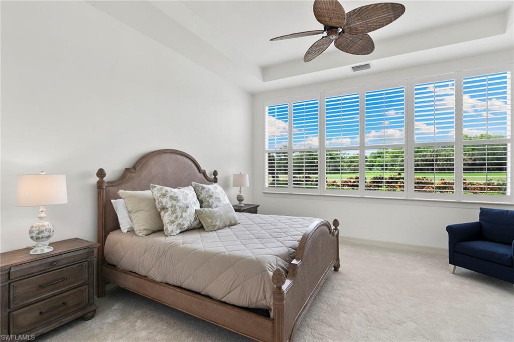 17005 Porta Vecchio Way, Unit 102 Naples, FL 34110 - Photo 15 of 50 a bedroom with a large bed and a large window