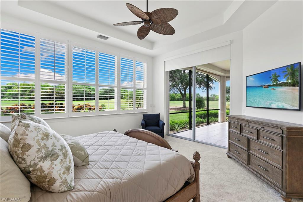 17005 Porta Vecchio Way, Unit 102 Naples, FL 34110 - Photo 16 of 50 a bed sitting in a bedroom next to a window