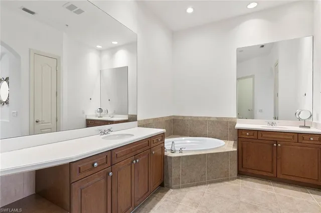 a bathroom with a sink double vanity and a bathtub