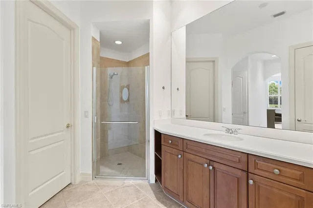 a bathroom with a shower sink and mirror