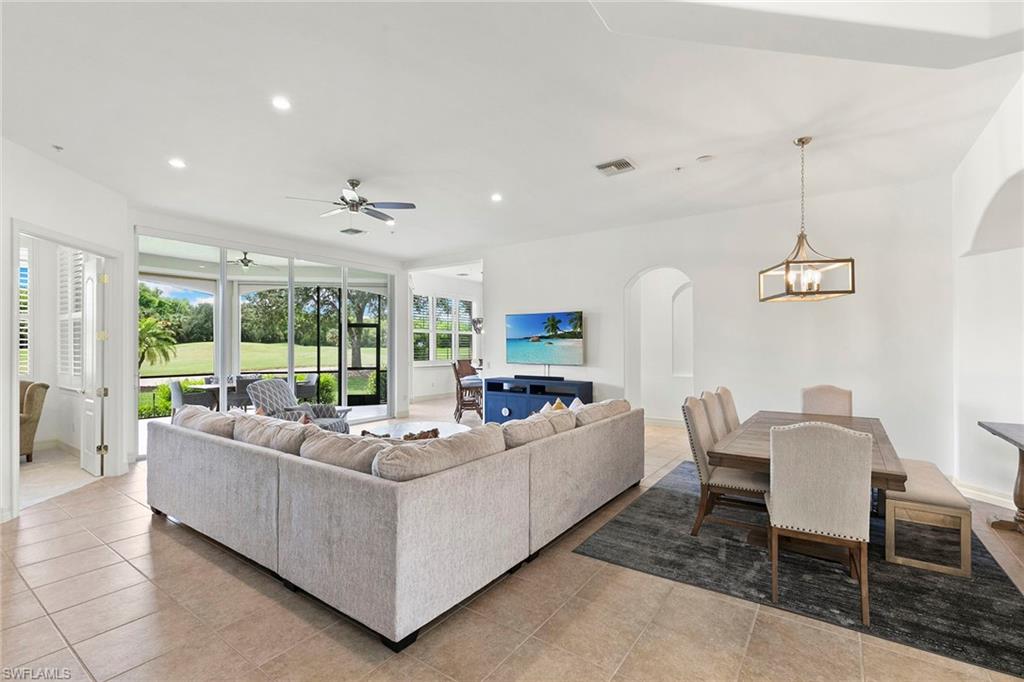 17005 Porta Vecchio Way, Unit 102 Naples, FL 34110 - Photo 2 of 50 a living room with furniture and a large window