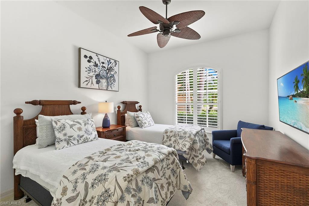 17005 Porta Vecchio Way, Unit 102 Naples, FL 34110 - Photo 23 of 50 a bedroom with a large bed and a window