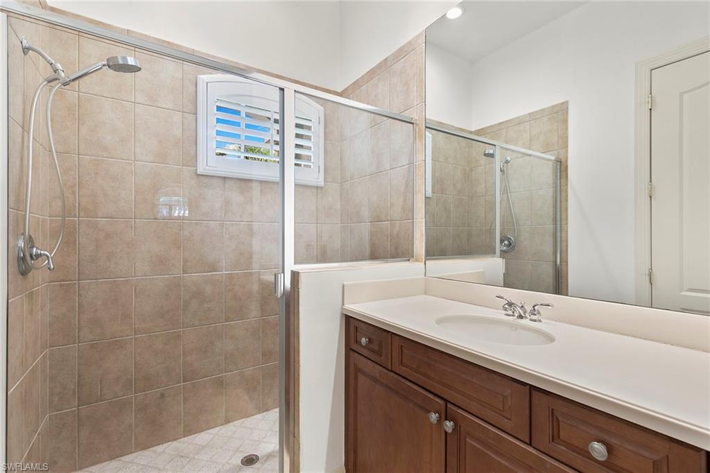 17005 Porta Vecchio Way, Unit 102 Naples, FL 34110 - Photo 24 of 50 a bathroom with a sink and a mirror