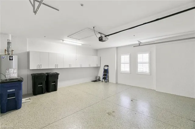 a view of a kitchen with a sink and a refrigerator
