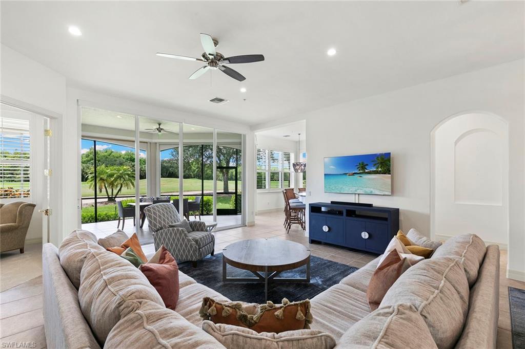 17005 Porta Vecchio Way, Unit 102 Naples, FL 34110 - Photo 3 of 50 a living room with furniture and a large window