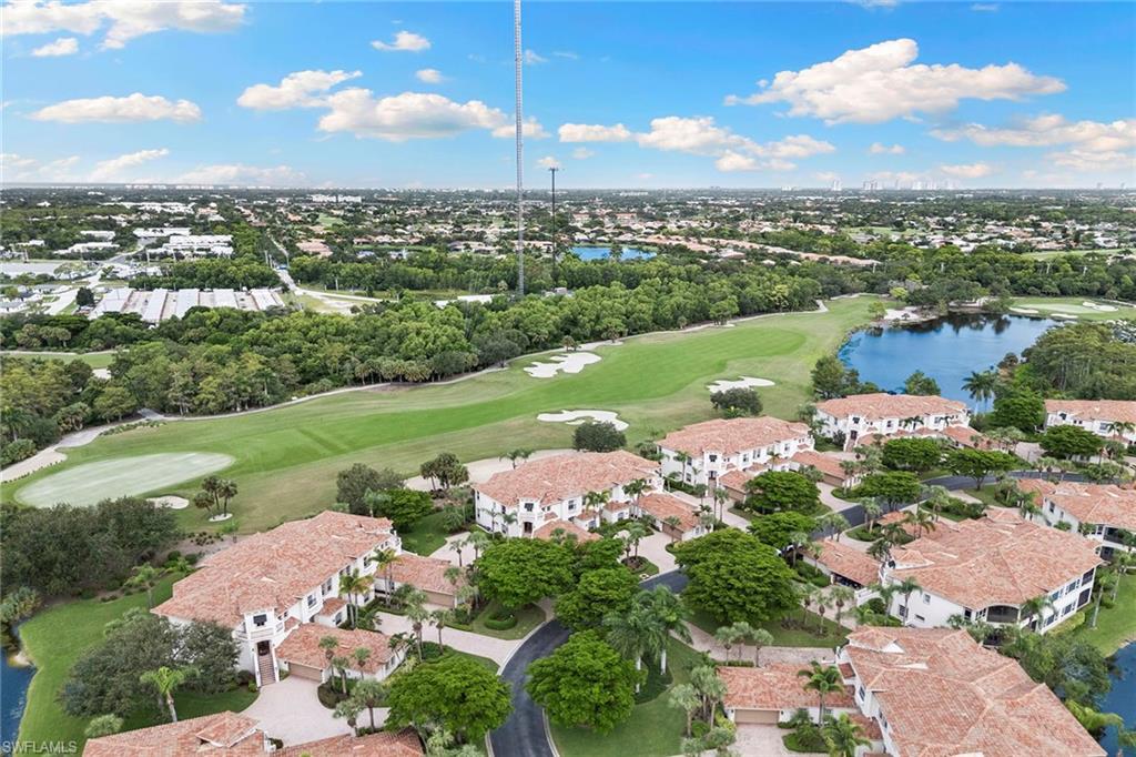17005 Porta Vecchio Way, Unit 102 Naples, FL 34110 - Photo 36 of 50 an aerial view of a city with lots of residential buildings ocean and mountain view in back