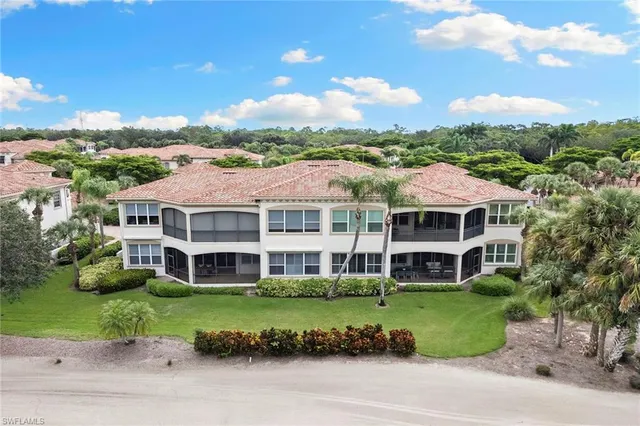 a view of a big house with a big yard and plants
