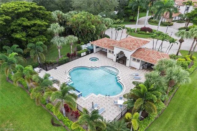 an aerial view of a house with yard swimming pool and outdoor seating