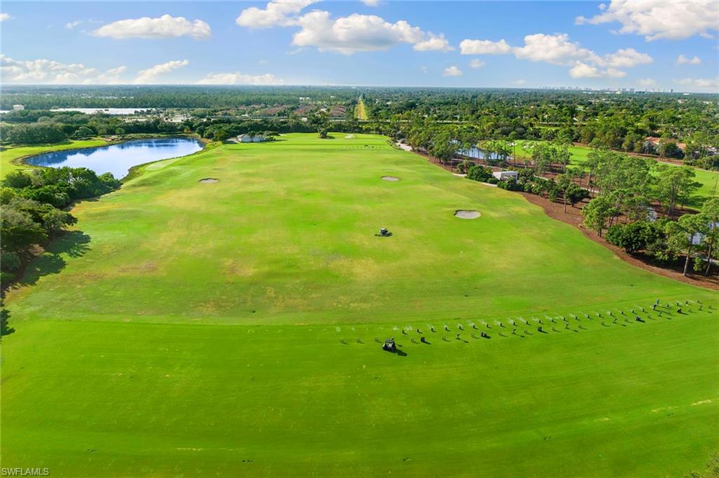 17005 Porta Vecchio Way, Unit 102 Naples, FL 34110 - Photo 43 of 50 a view of a big yard with a large tree and a plant