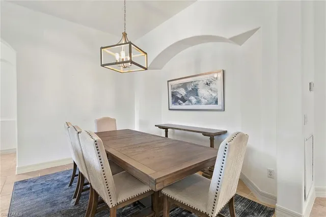 a view of a dining room with furniture wooden floor and a chandelier