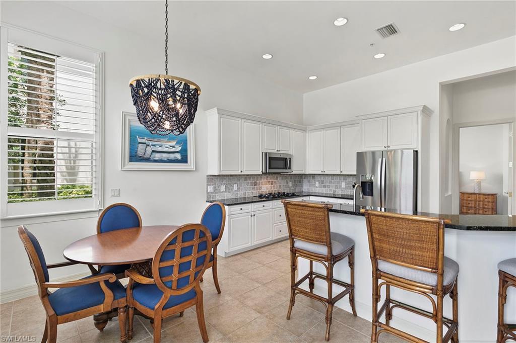 17005 Porta Vecchio Way, Unit 102 Naples, FL 34110 - Photo 10 of 50 a dining room with furniture and window