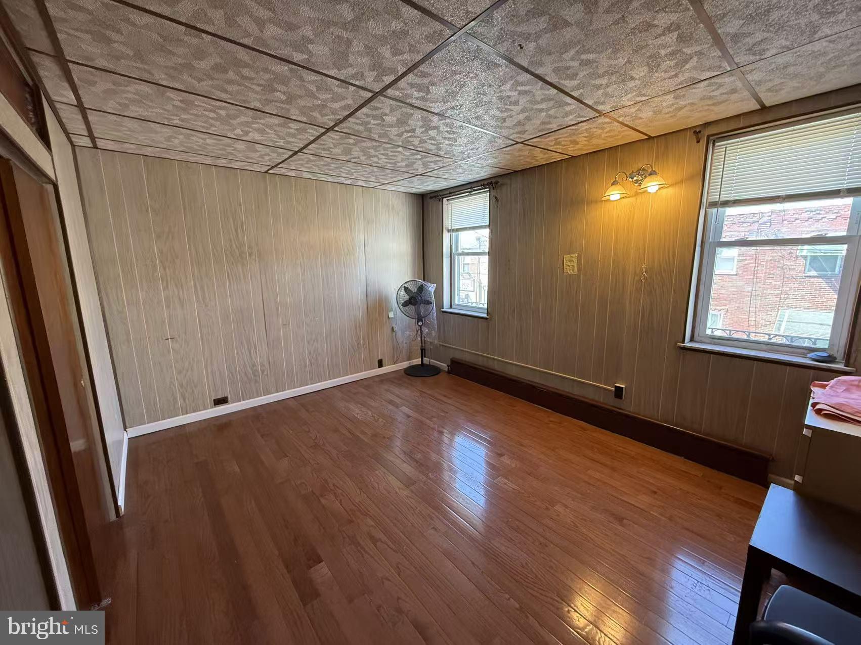 1733 South 9th Street Philadelphia, PA 19148 - Photo 12 of 14 an empty room with wooden floor and windows