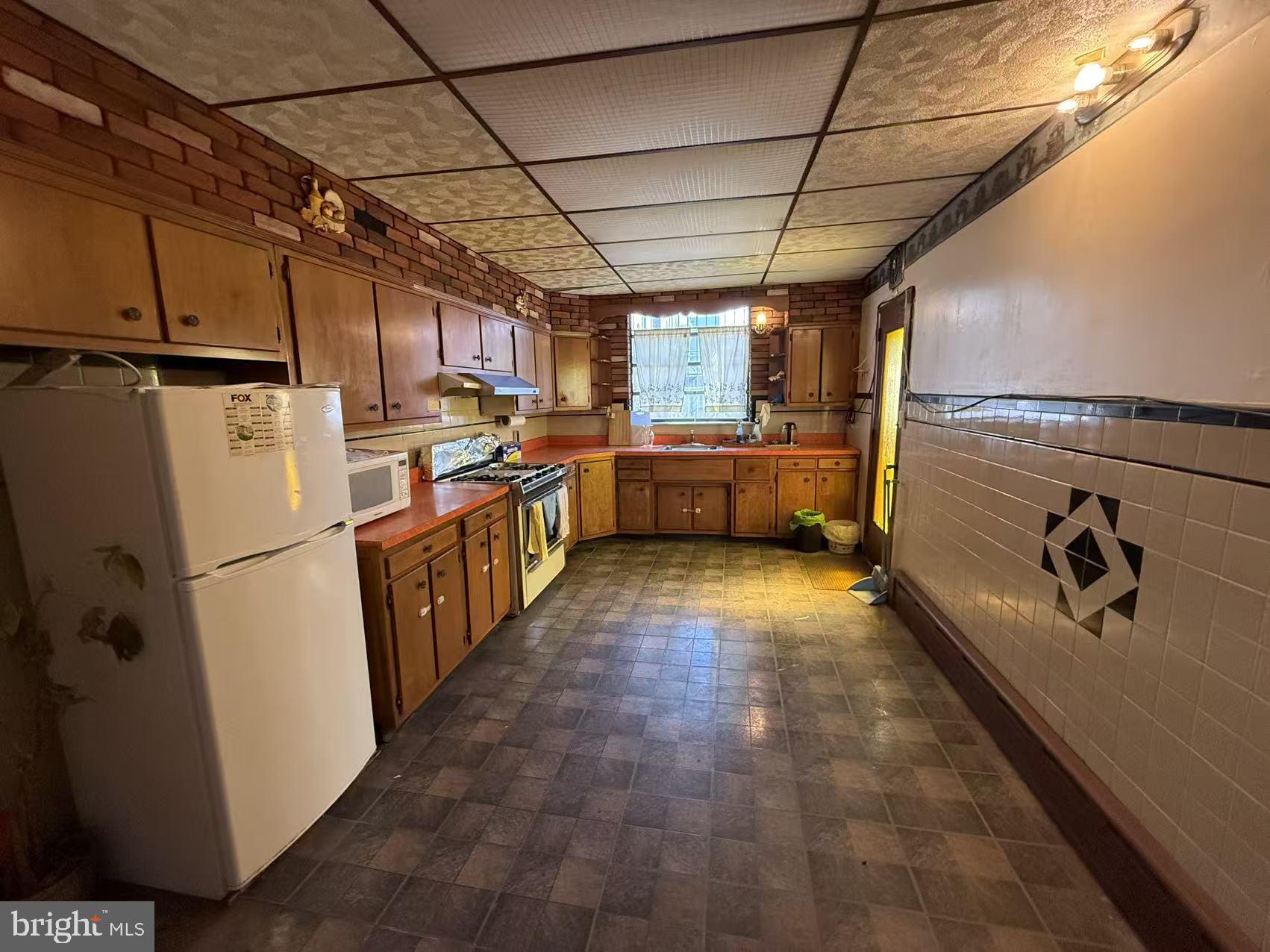 1733 South 9th Street Philadelphia, PA 19148 - Photo 6 of 14 a kitchen with sink cabinets and refrigerator