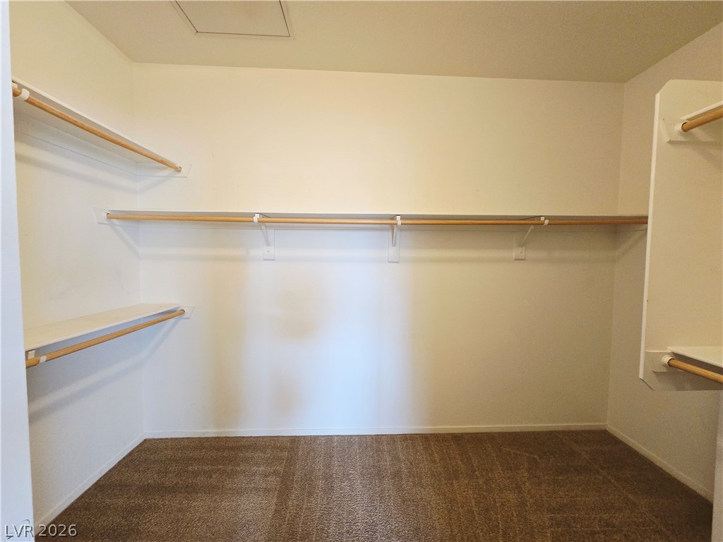 9580 West Reno Avenue, Unit 283 Las Vegas, NV 89148 - Photo 8 of 19 Walk in closet with dark carpet