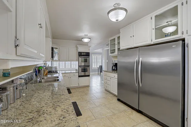 a large kitchen with cabinets and stainless steel appliances