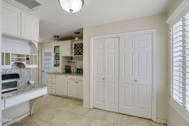 a kitchen with stainless steel appliances granite countertop a sink and cabinets