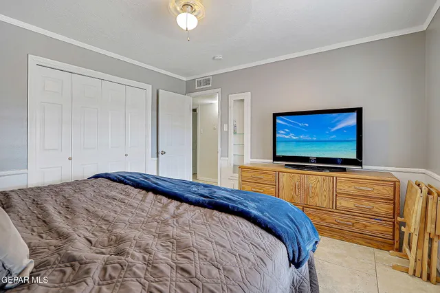 a bedroom with two beds and a chandelier