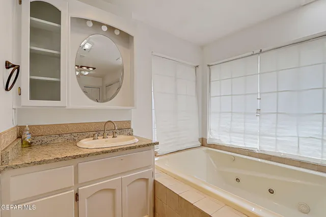 a bathroom with a tub and a sink