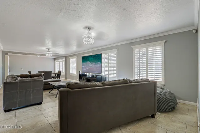 a living room with furniture and a chandelier