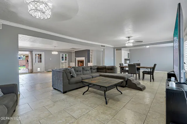 a living room with furniture a large window and a flat screen tv