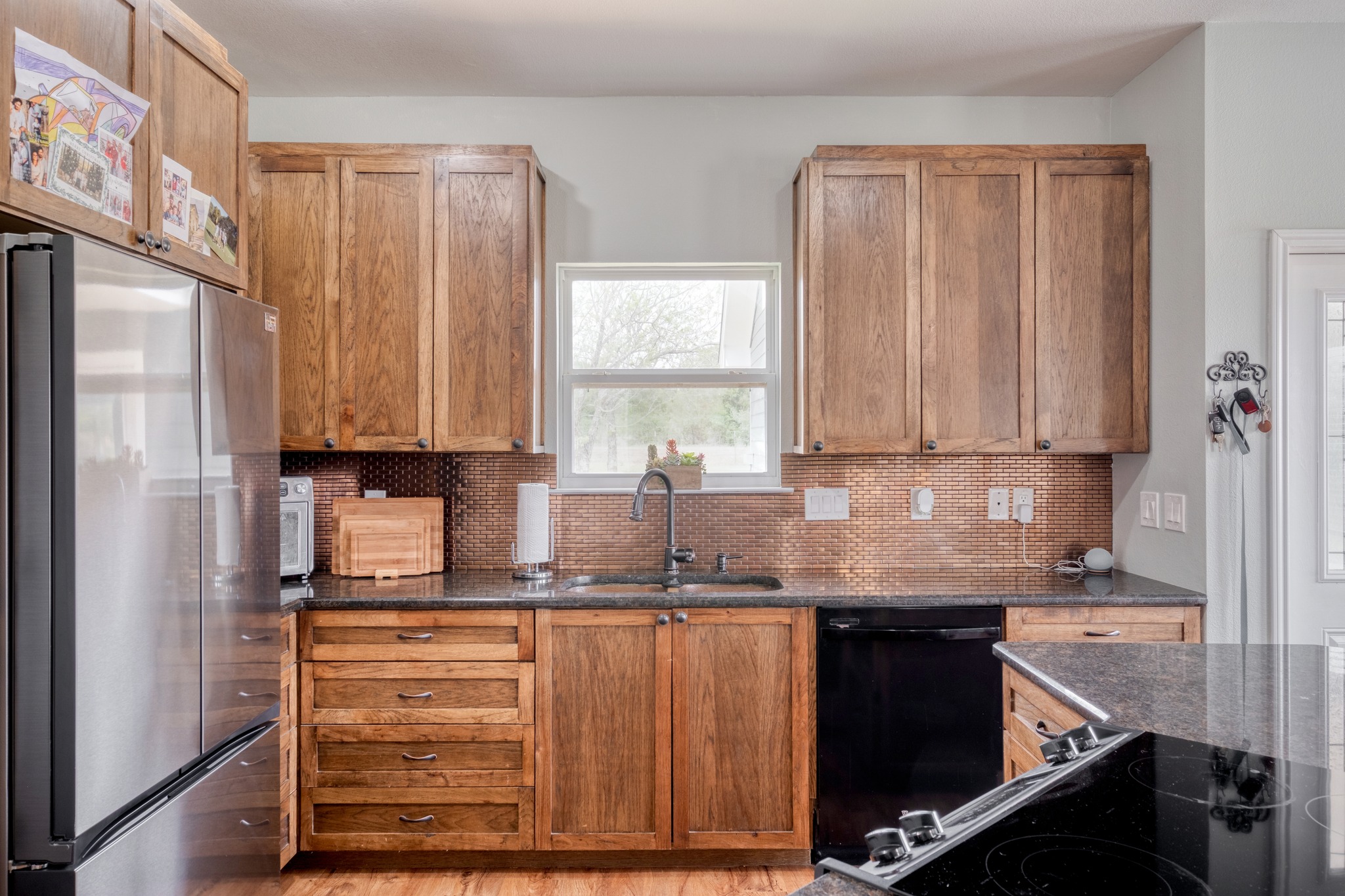 2950 County Road 484 Elgin, TX 78621 - Photo 12 of 25 a kitchen with granite countertop a sink stainless steel appliances and cabinets