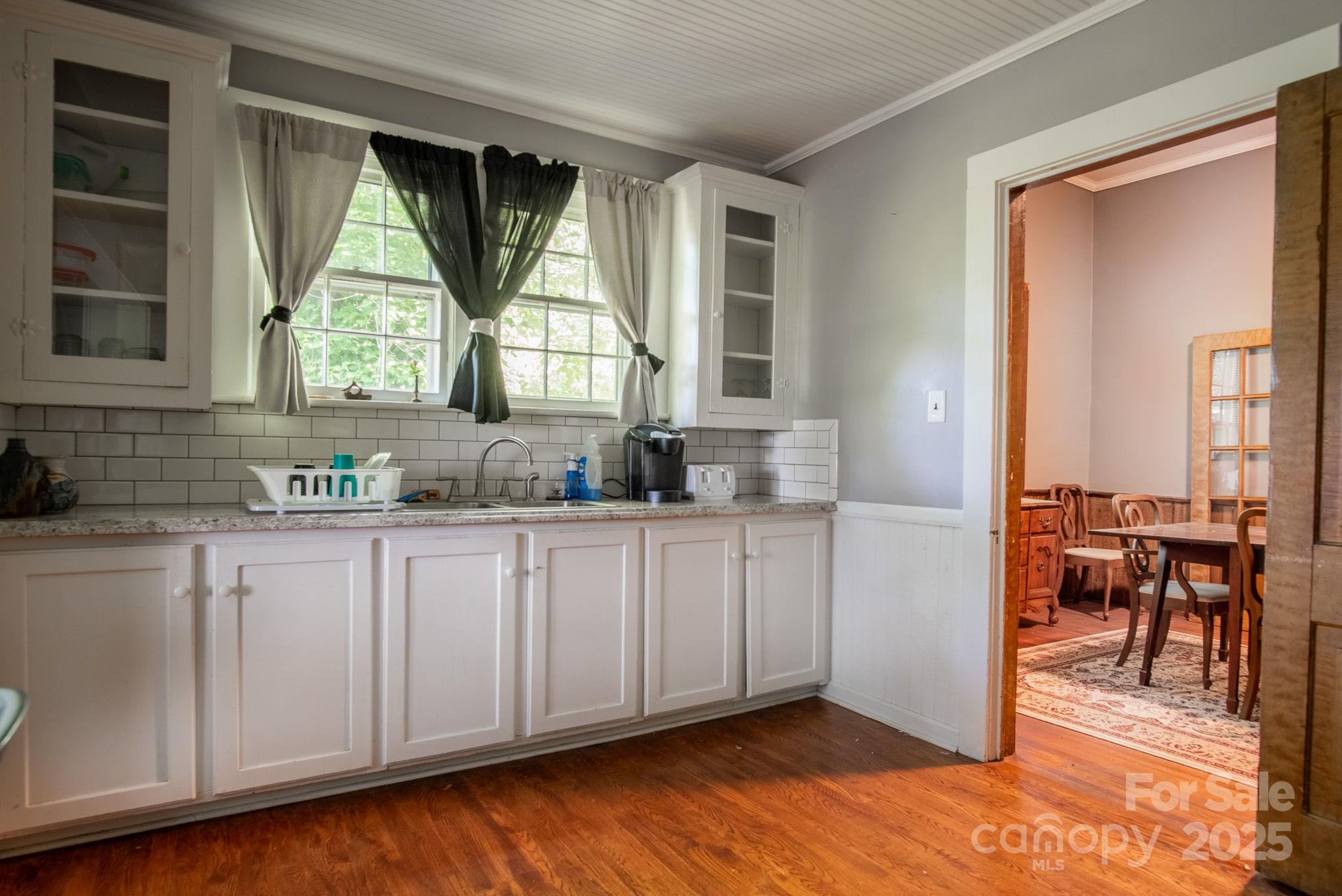 109 Fulton Street, Unit 9 Kings Mountain, NC 28086 - Photo 14 of 46 a kitchen with granite countertop a window a sink and cabinets