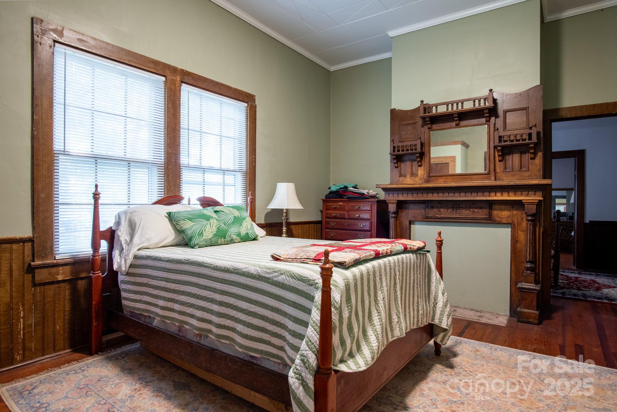 109 Fulton Street, Unit 9 Kings Mountain, NC 28086 - Photo 19 of 46 a bedroom with bed and wooden floor