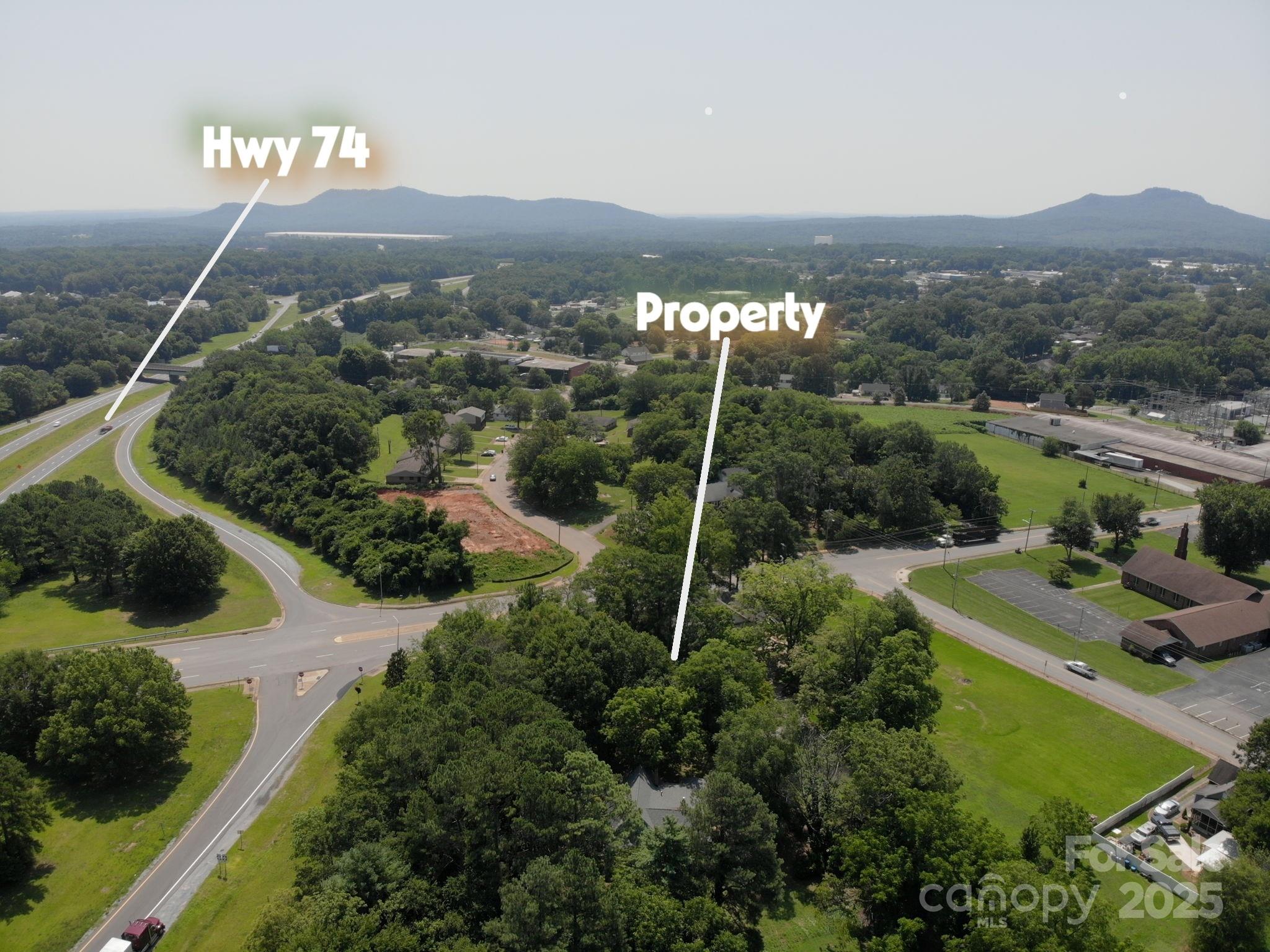 109 Fulton Street, Unit 9 Kings Mountain, NC 28086 - Photo 2 of 46 a view of a garden with a building in the background