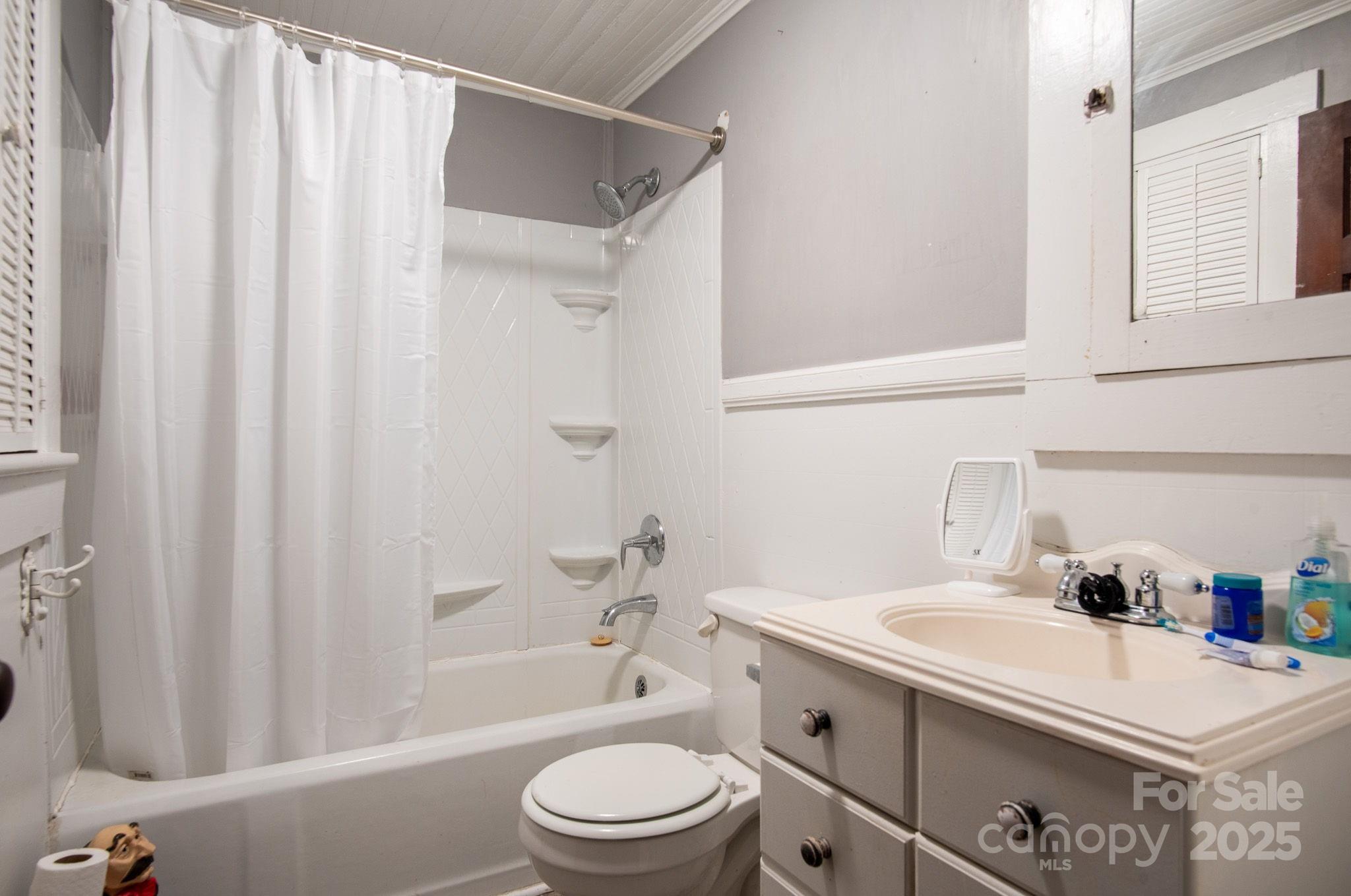 109 Fulton Street, Unit 9 Kings Mountain, NC 28086 - Photo 23 of 46 a bathroom with a sink a toilet and shower curtain