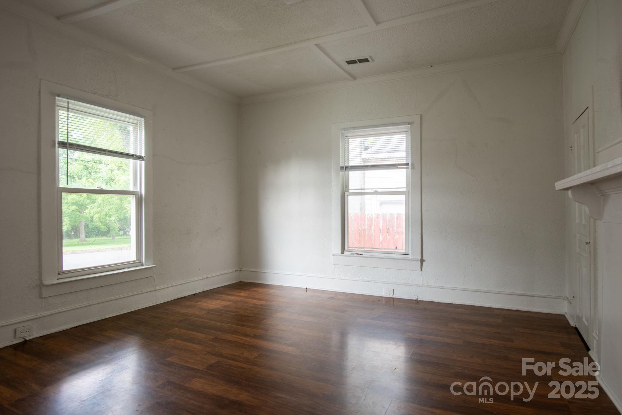 109 Fulton Street, Unit 9 Kings Mountain, NC 28086 - Photo 34 of 46 an empty room with wooden floor and windows