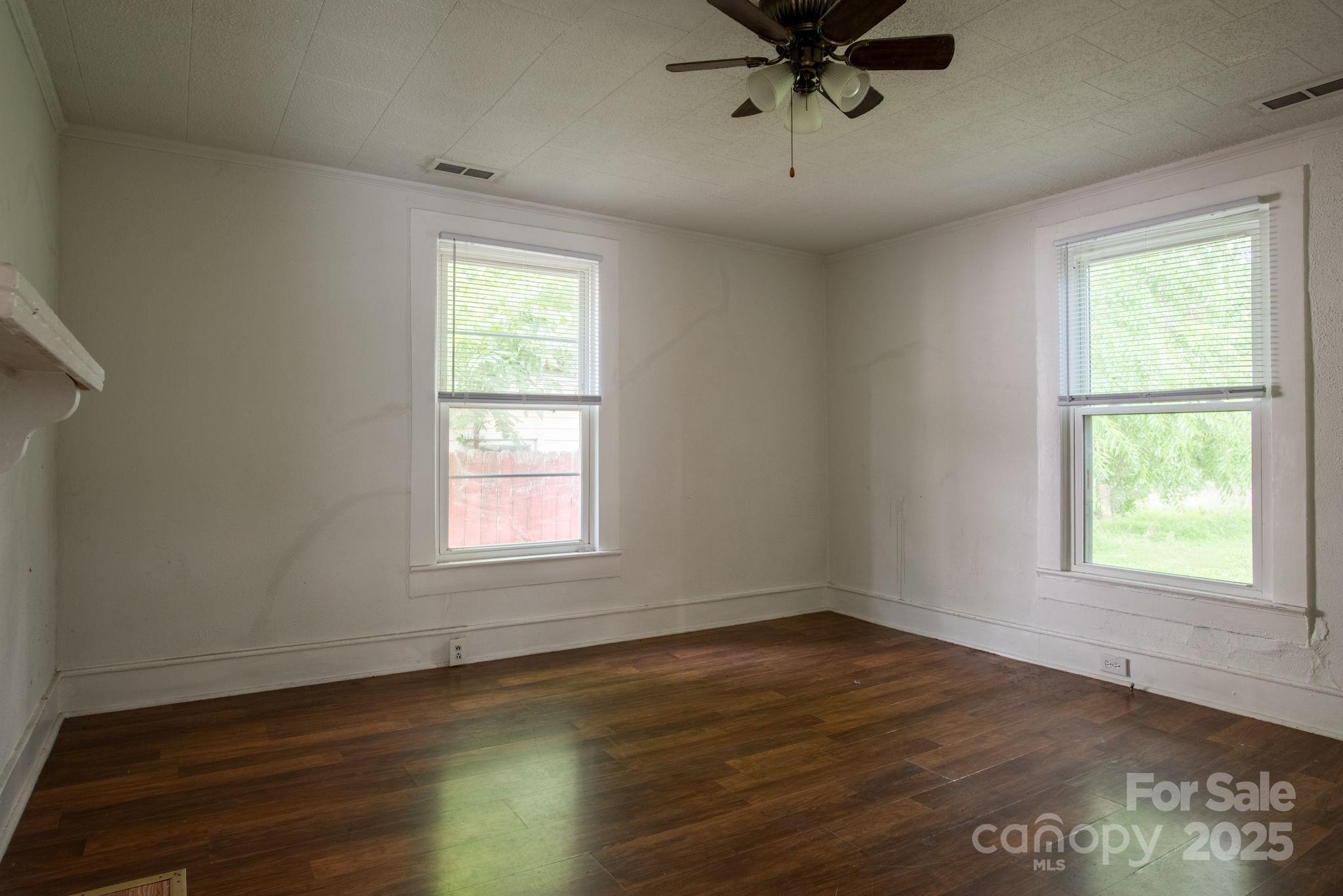109 Fulton Street, Unit 9 Kings Mountain, NC 28086 - Photo 36 of 46 a view of an empty room with wooden floor and a window