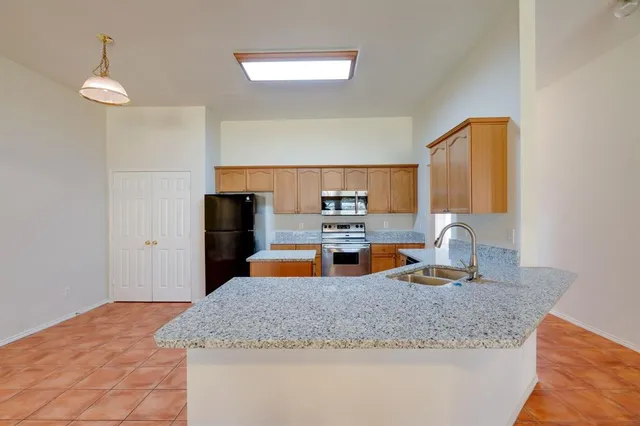 a kitchen with granite countertop a sink and cabinets