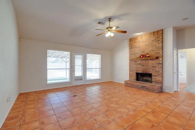 a view of a kitchen with kitchen island a sink and a fireplace