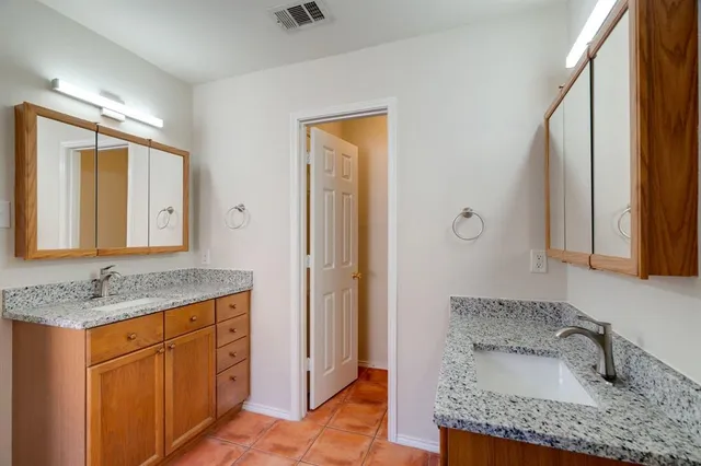 a view of a small space with wooden floor and a window