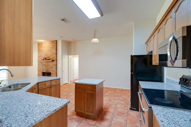 a kitchen that has a microwave a sink and a stove in it