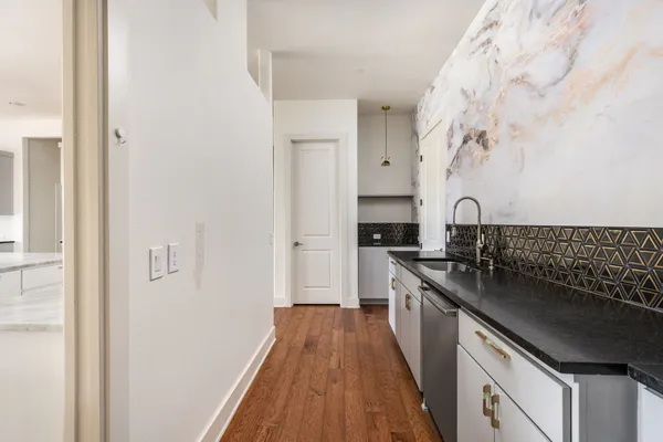 a kitchen with stainless steel appliances granite countertop a stove and a refrigerator