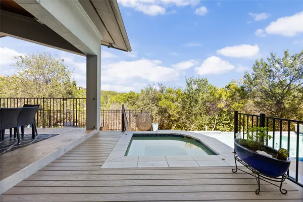 a view of balcony with wooden floor and seating space