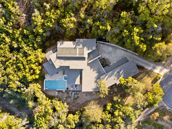 an aerial view of a house with a yard and garden