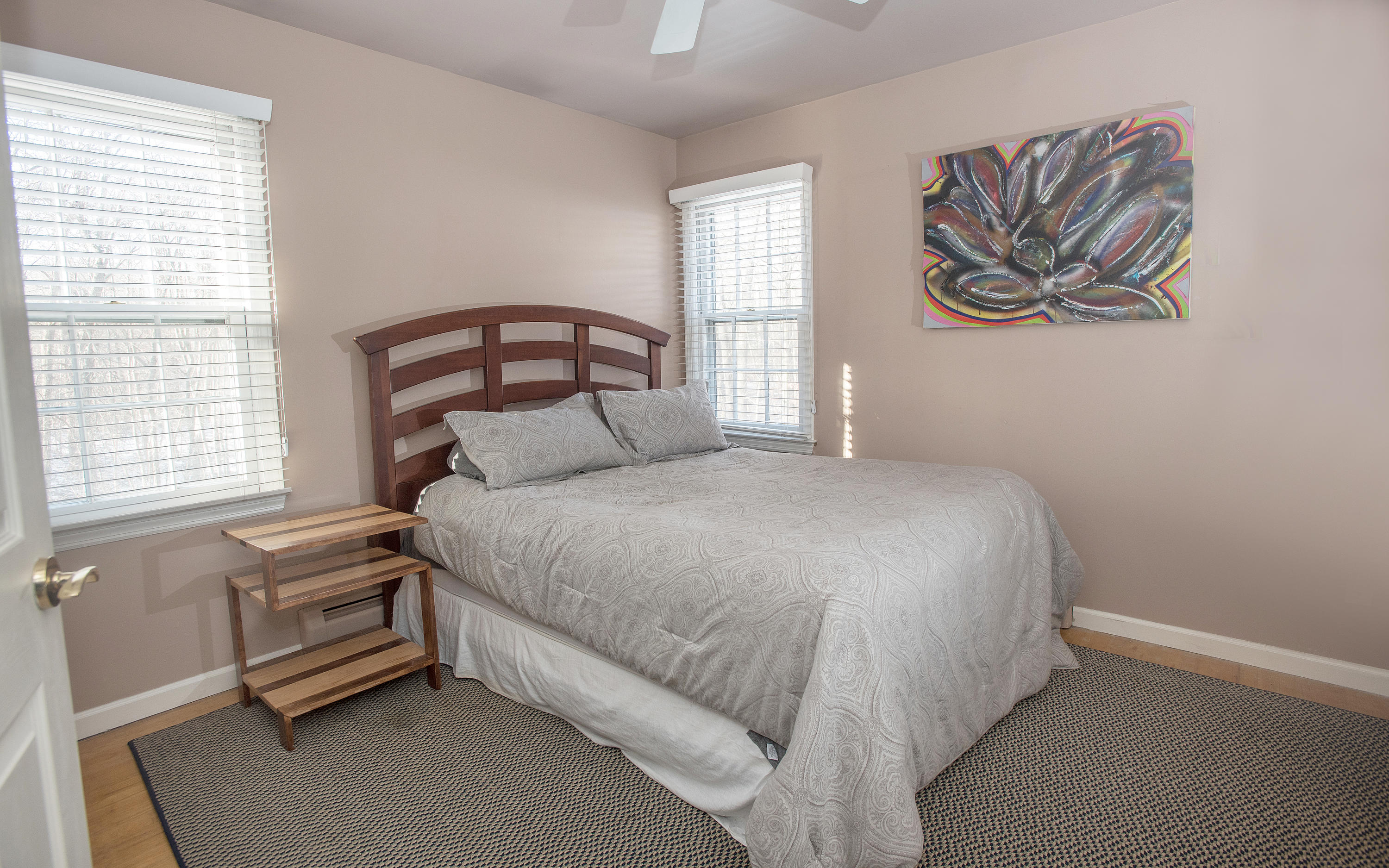 286 Indian Rock Road New Canaan, CT 06840 - Photo 17 of 24 a bedroom with a bed and a painting on the wall