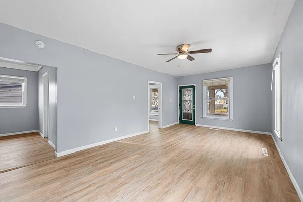 wooden floor in an empty room with a window
