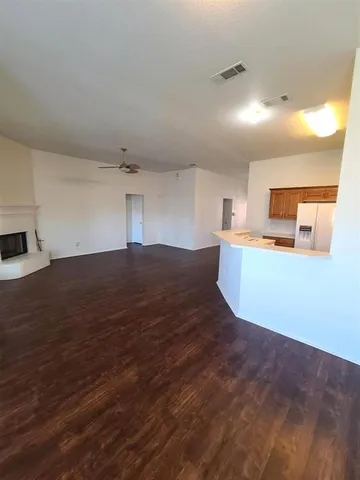 a view of a kitchen with wooden floor and a sink