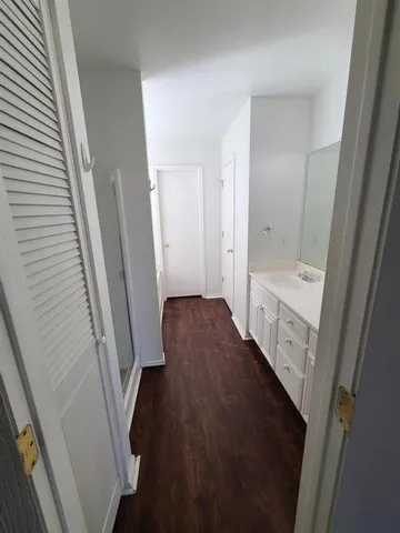 a bathroom with a double vanity sink toilet and shower