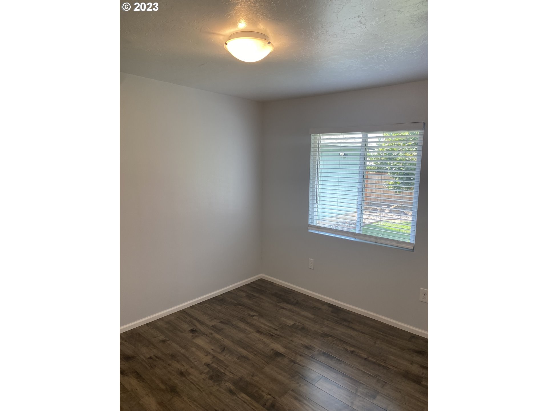 954 Aldridge Place Springfield, OR 97478 - Photo 13 of 32 a view of an empty room with wooden floor and a window