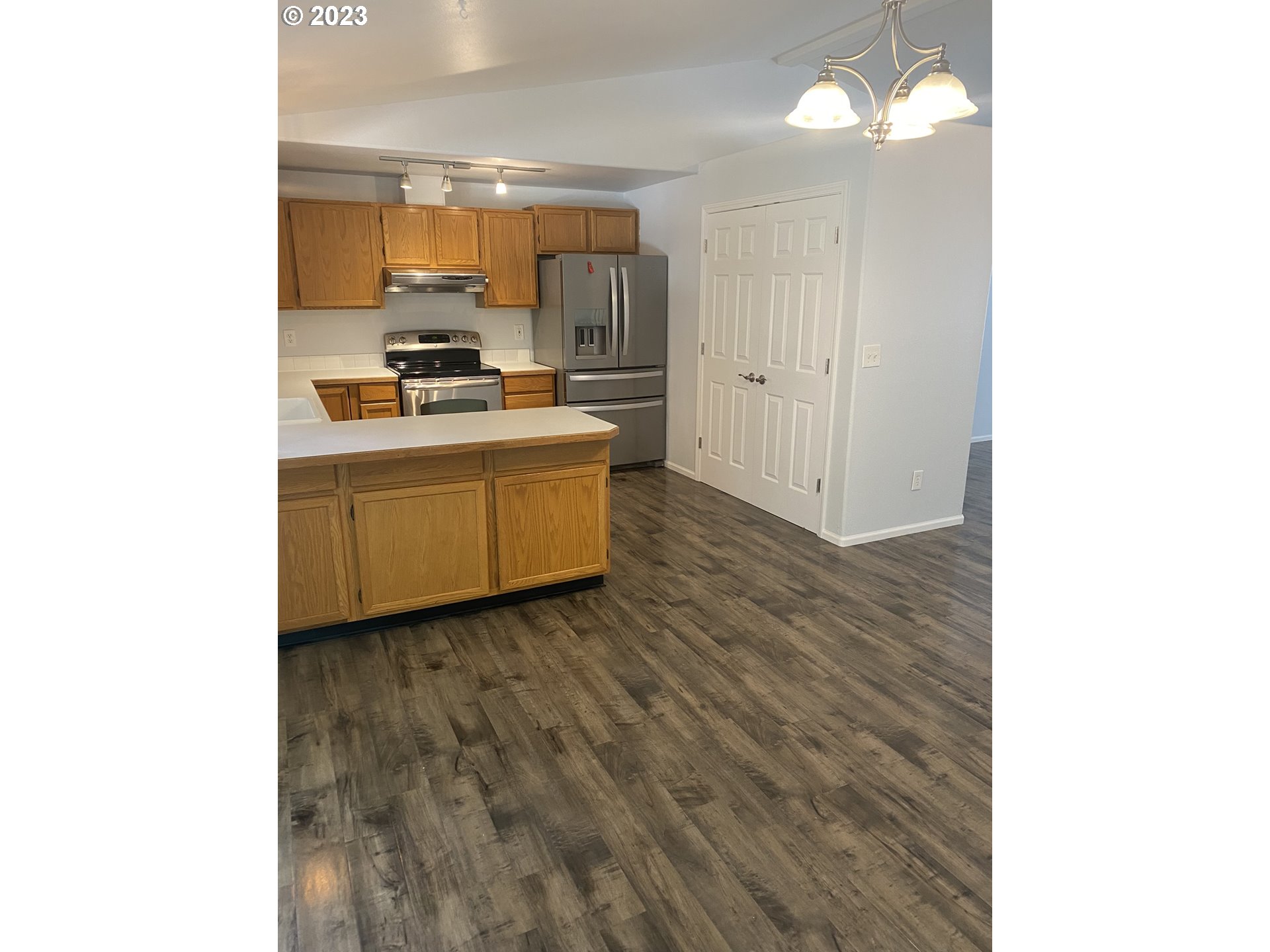 954 Aldridge Place Springfield, OR 97478 - Photo 5 of 32 a room with kitchen island stainless steel appliances a sink and cabinets