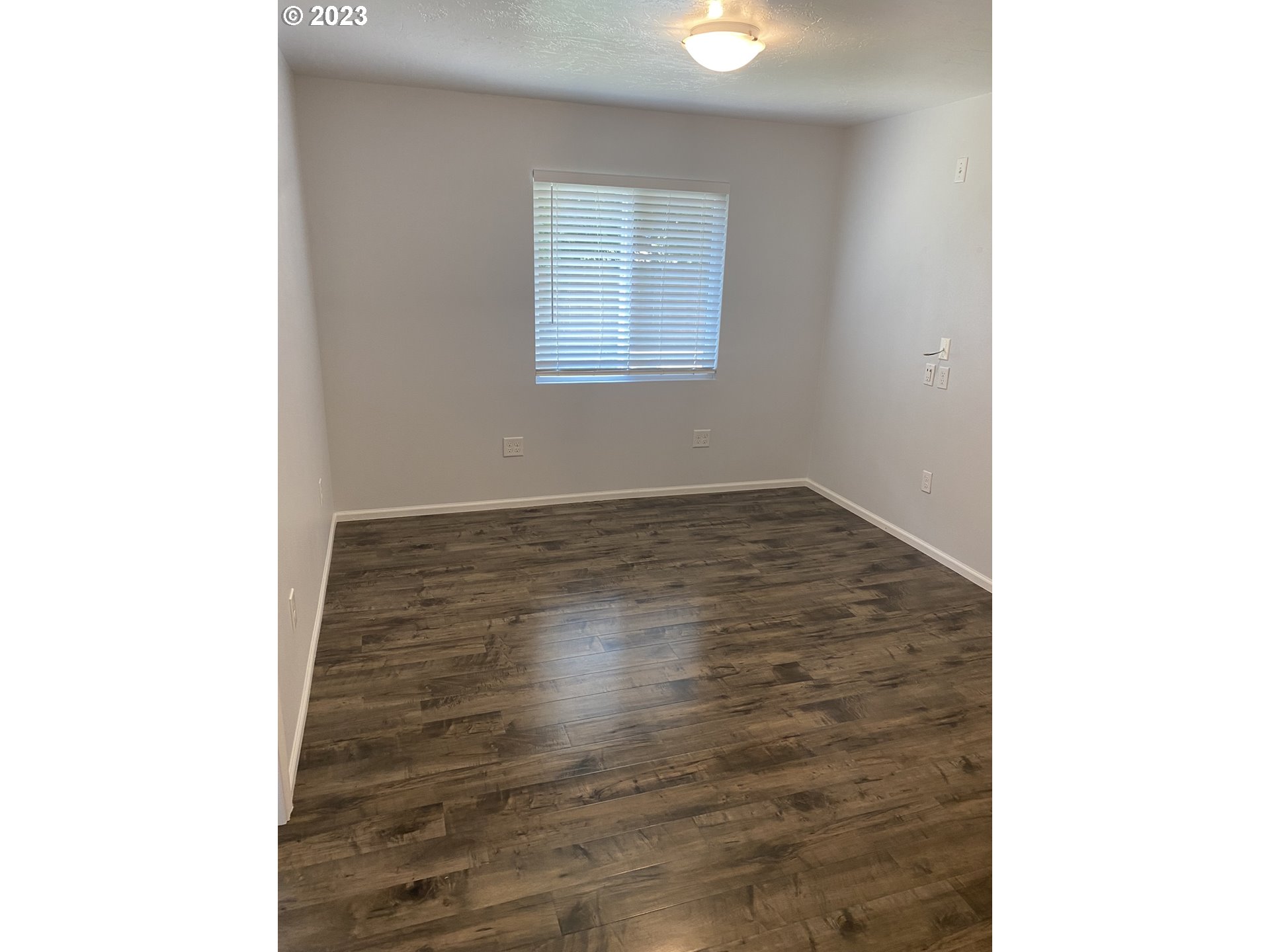 954 Aldridge Place Springfield, OR 97478 - Photo 10 of 32 a view of an empty room with wooden floor and a window